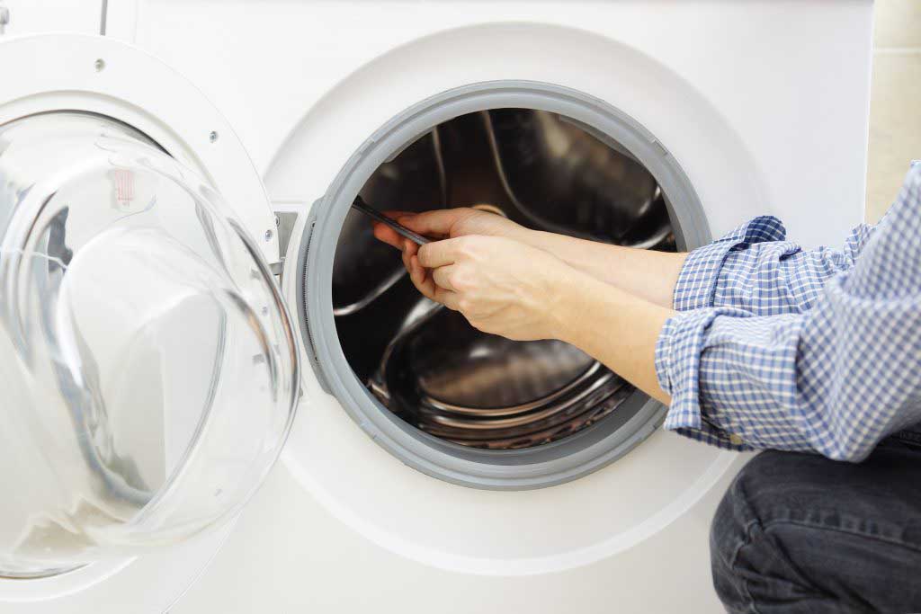 Technician repairing a dryer