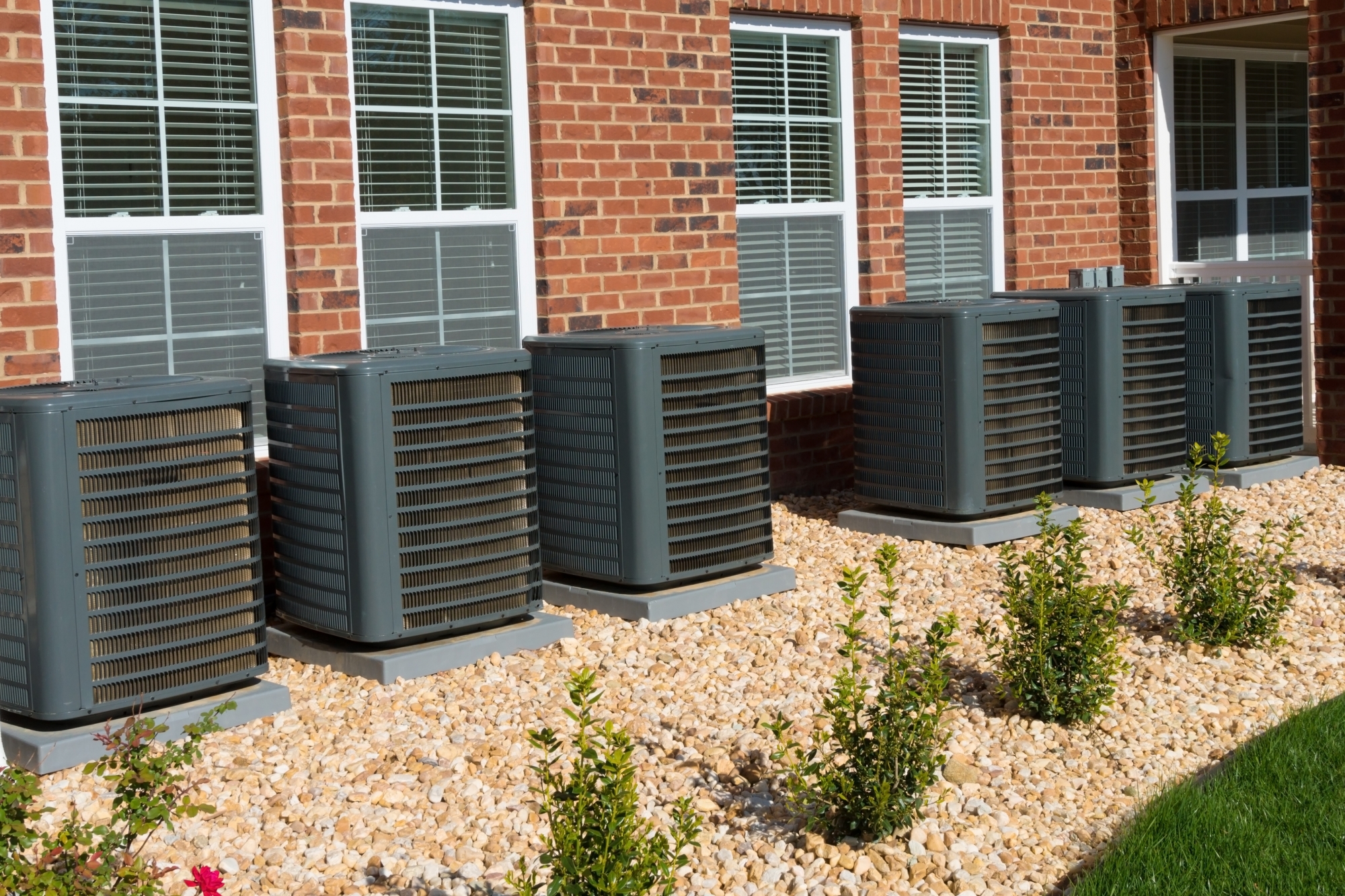 Line up of air conditioning units outside of office building