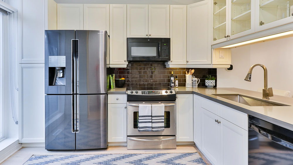 Kitchen with Samsung refrigerator and GE microwave oven